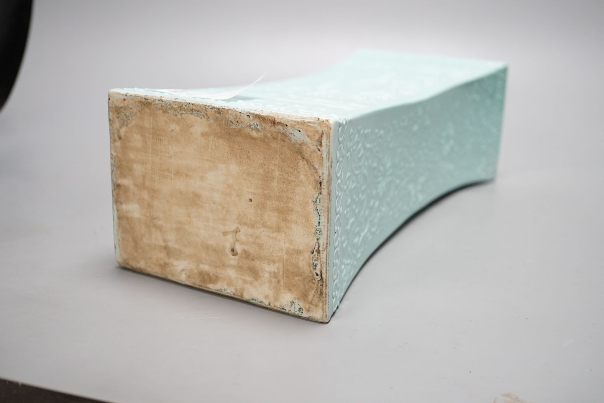 A Chinese turquoise glazed pillow, 33 cms wide.